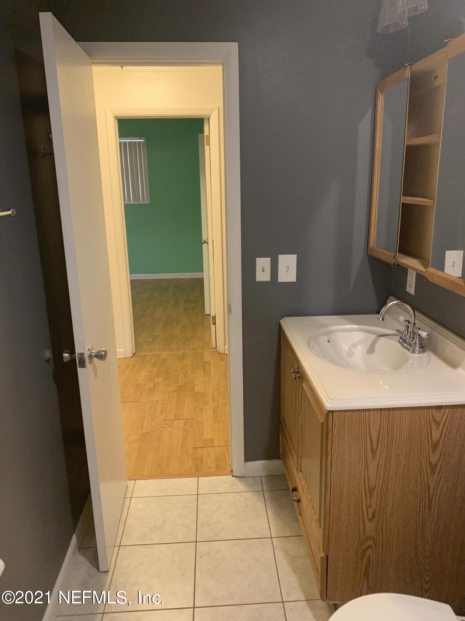 4126 Dayrl Road Jacksonville, FL 32207 - Photo 17 of 26 a bathroom with a sink and a mirror