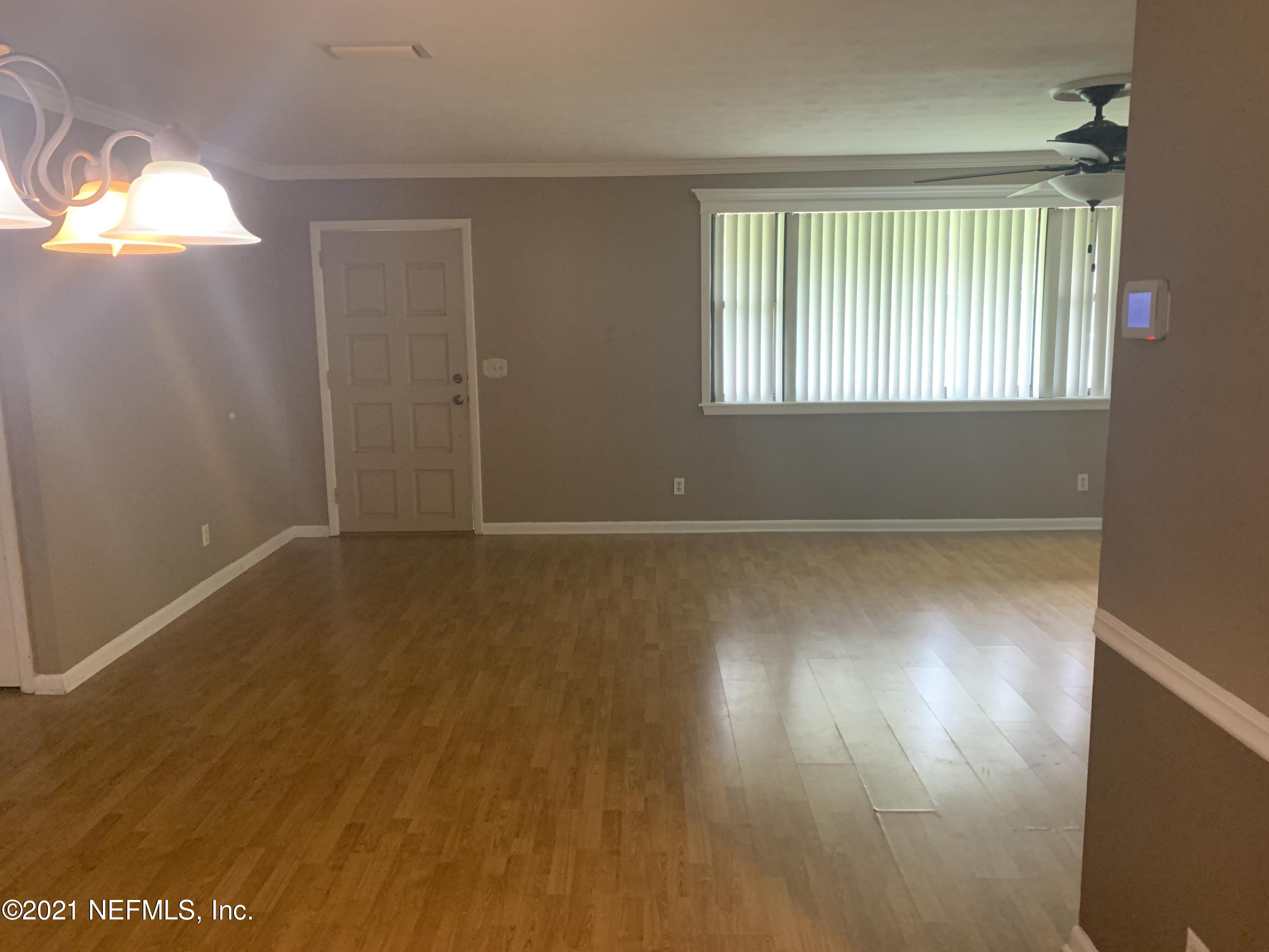 4126 Dayrl Road Jacksonville, FL 32207 - Photo 5 of 26 an empty room with wooden floor and windows