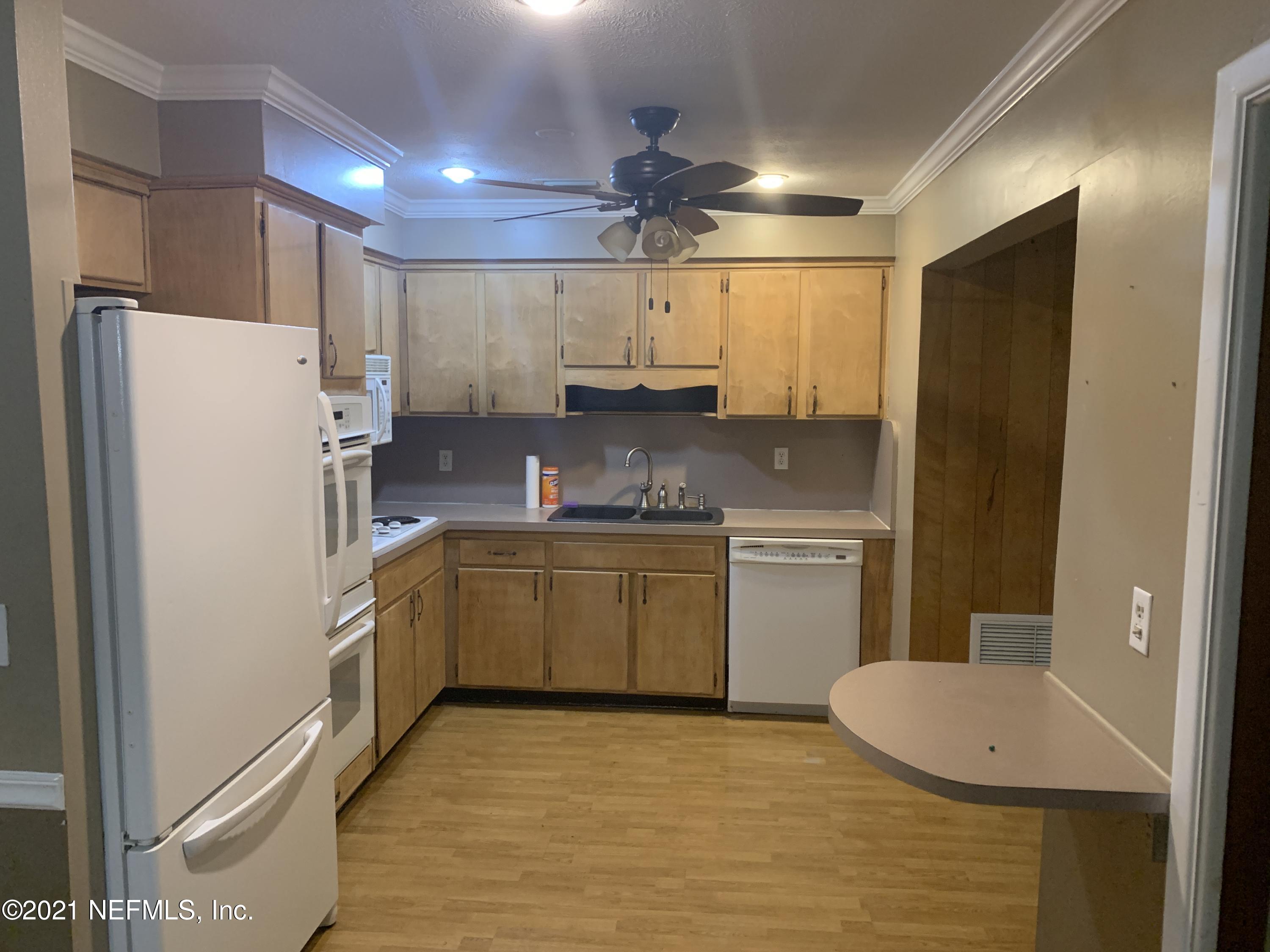 4126 Dayrl Road Jacksonville, FL 32207 - Photo 6 of 26 a kitchen with a refrigerator sink stove and cabinets