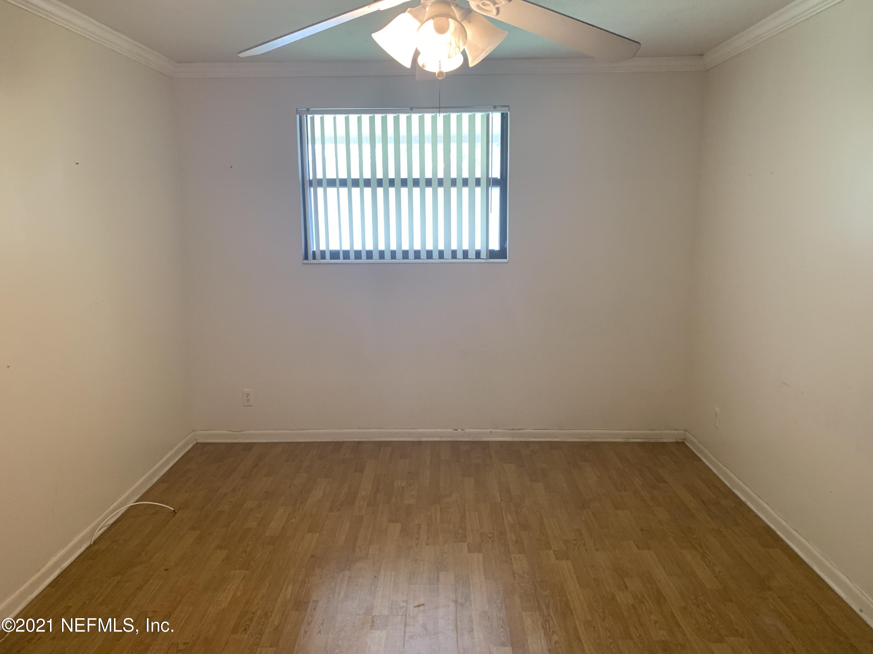4126 Dayrl Road Jacksonville, FL 32207 - Photo 8 of 26 an empty room with wooden floor and windows