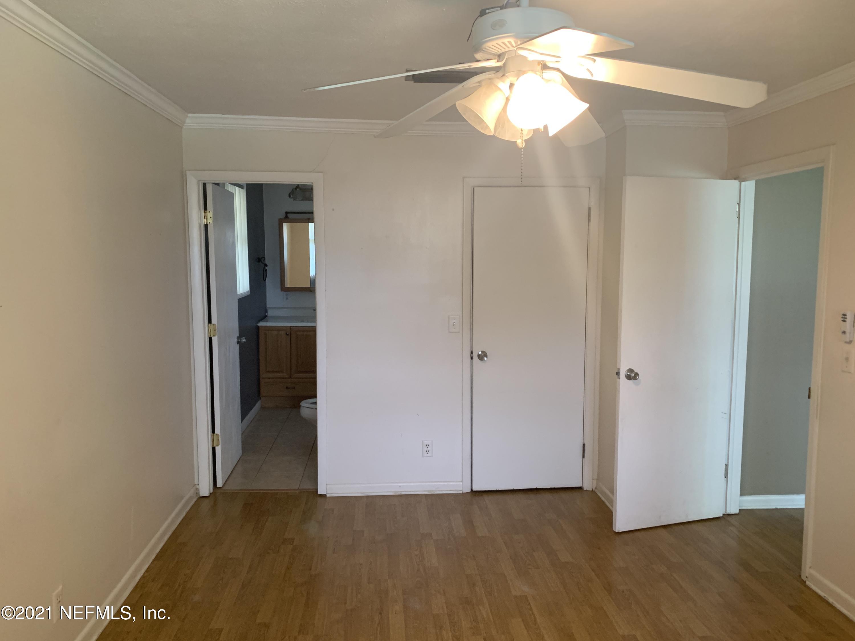 4126 Dayrl Road Jacksonville, FL 32207 - Photo 9 of 26 a view of empty room with window and wooden floor