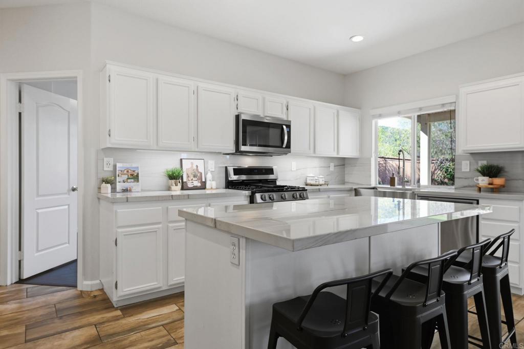 5051 Lake Circle Road Fallbrook, CA 92028 - Photo 10 of 50 a white kitchen with a sink and cabinets