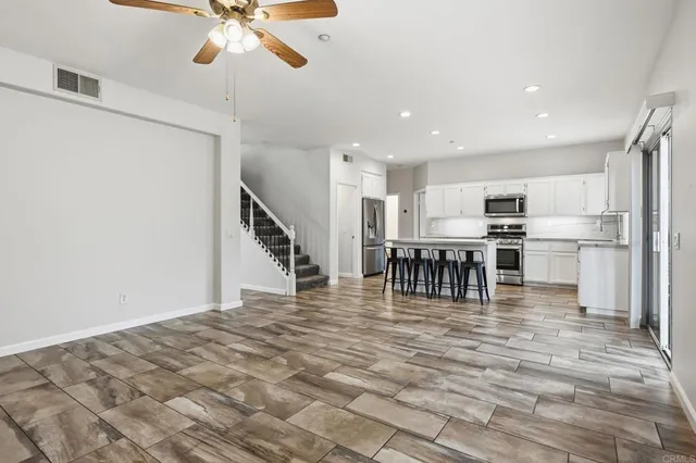 a view of an empty room with a fireplace and a window