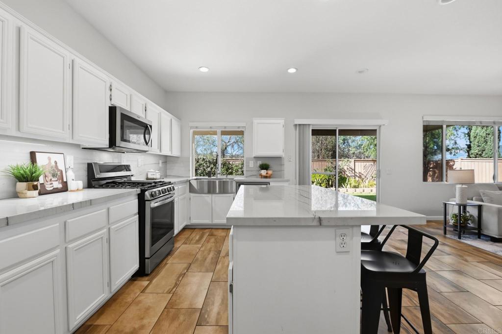 5051 Lake Circle Road Fallbrook, CA 92028 - Photo 11 of 50 a kitchen with granite countertop sink cabinets and stainless steel appliances