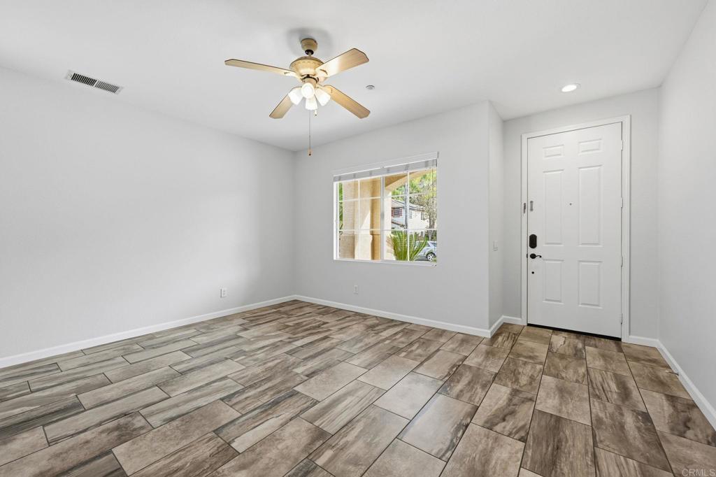 5051 Lake Circle Road Fallbrook, CA 92028 - Photo 16 of 57 a view of empty room with wooden floor and fan