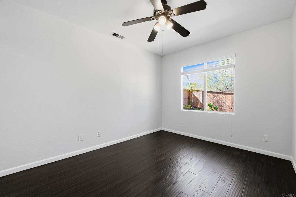 5051 Lake Circle Road Fallbrook, CA 92028 - Photo 16 of 50 a view of an empty room with wooden floor and a window