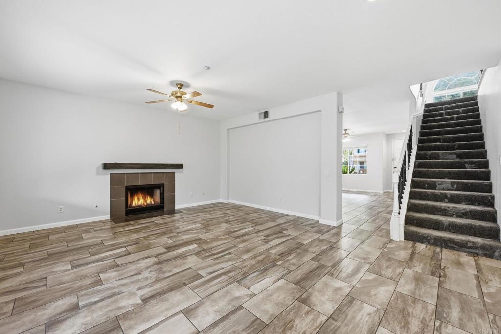5051 Lake Circle Road Fallbrook, CA 92028 - Photo 19 of 57 a view of an empty room with a fireplace and chandelier fan