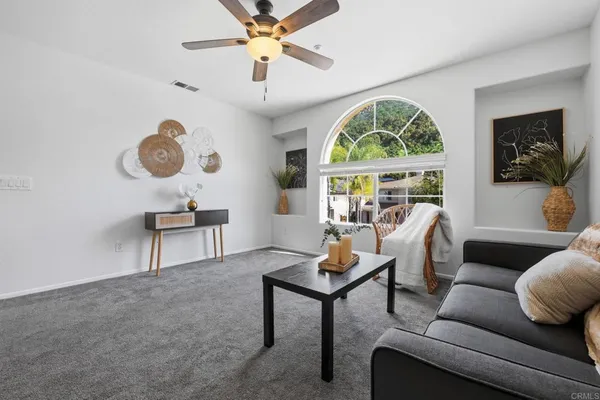 a living room with furniture and windows