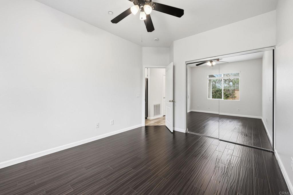 5051 Lake Circle Road Fallbrook, CA 92028 - Photo 22 of 57 an empty room with wooden floor cabinet and windows