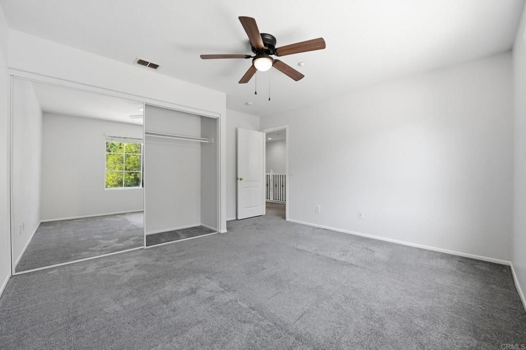 5051 Lake Circle Road Fallbrook, CA 92028 - Photo 21 of 50 an empty room with windows and ceiling fan
