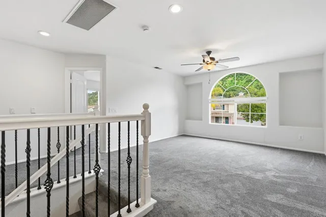an ocean view with a ceiling fan and a window