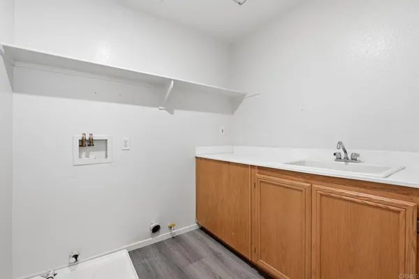 an empty room with windows and ceiling fan