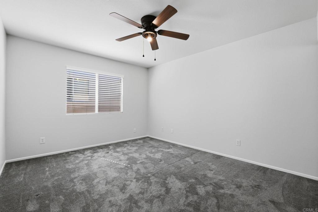 5051 Lake Circle Road Fallbrook, CA 92028 - Photo 23 of 50 an empty room with a window and a fan