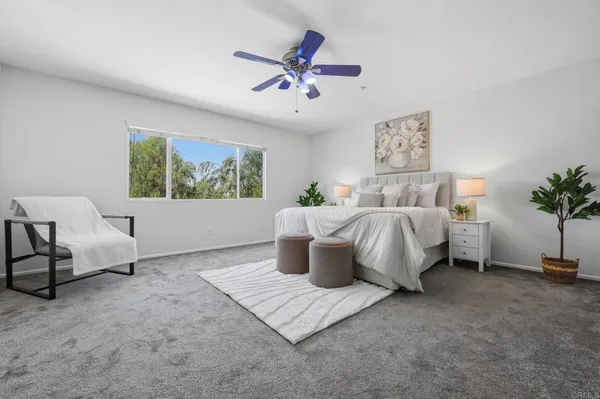 a bedroom with furniture and a window