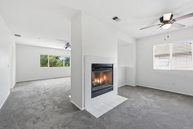 a view of an empty room with a fireplace