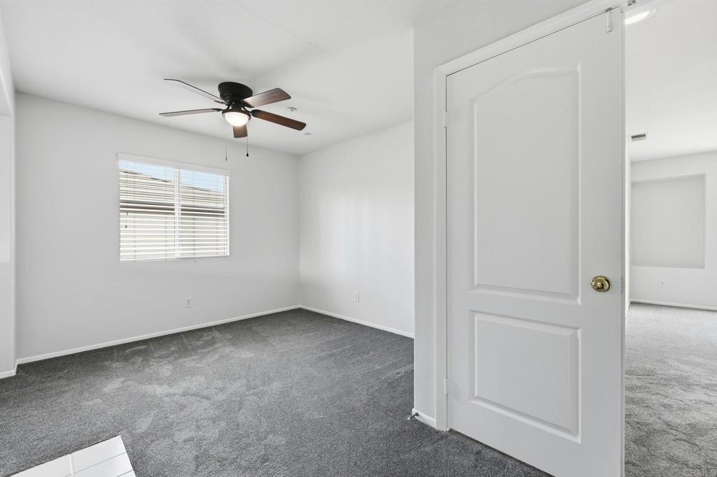 5051 Lake Circle Road Fallbrook, CA 92028 - Photo 29 of 57 an empty room with windows and fan