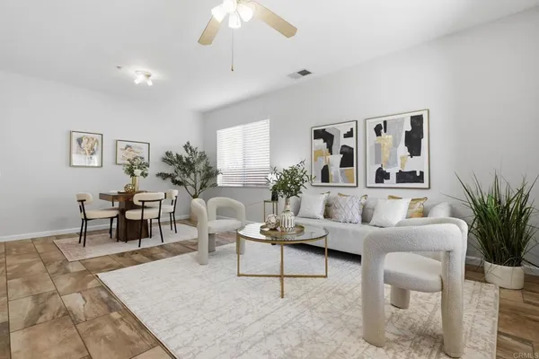 a living room with furniture and a potted plant