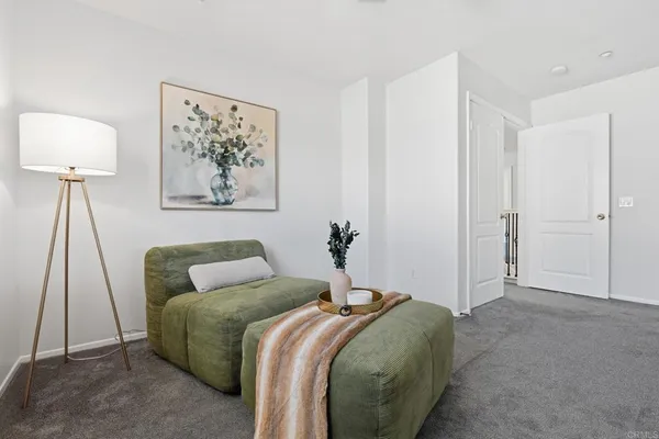 a bedroom with a bed and a lamp