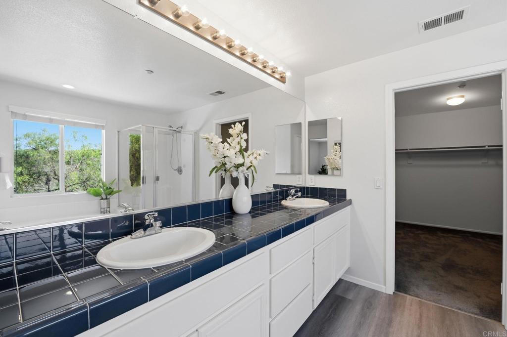 5051 Lake Circle Road Fallbrook, CA 92028 - Photo 33 of 50 a bathroom with a granite countertop sink and a mirror