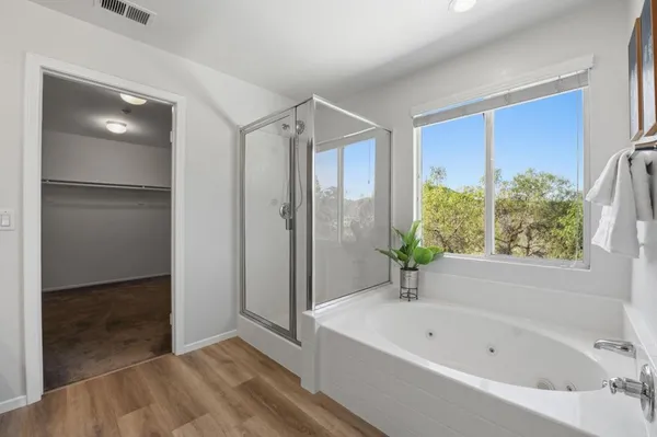 a bathroom with a bathtub and a shower