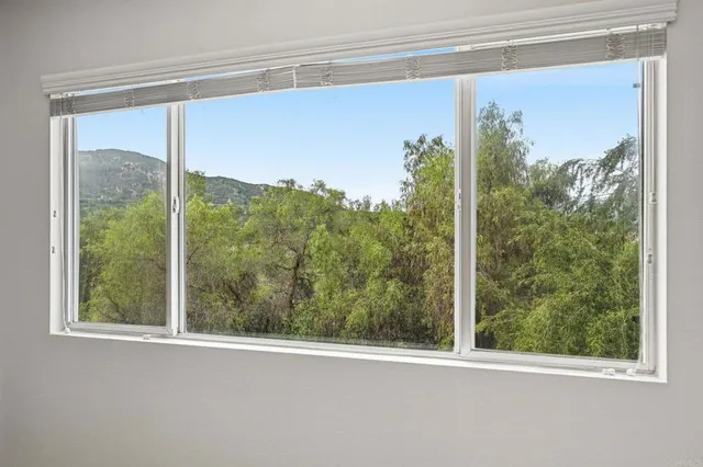 an empty room with a ceiling fan and shower
