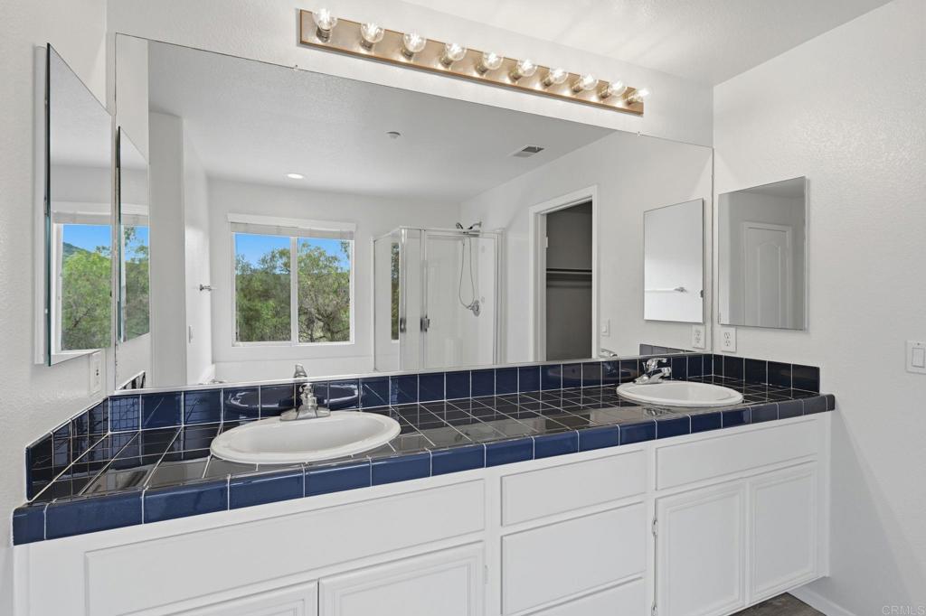 5051 Lake Circle Road Fallbrook, CA 92028 - Photo 37 of 57 a bathroom with a granite countertop sink and a mirror