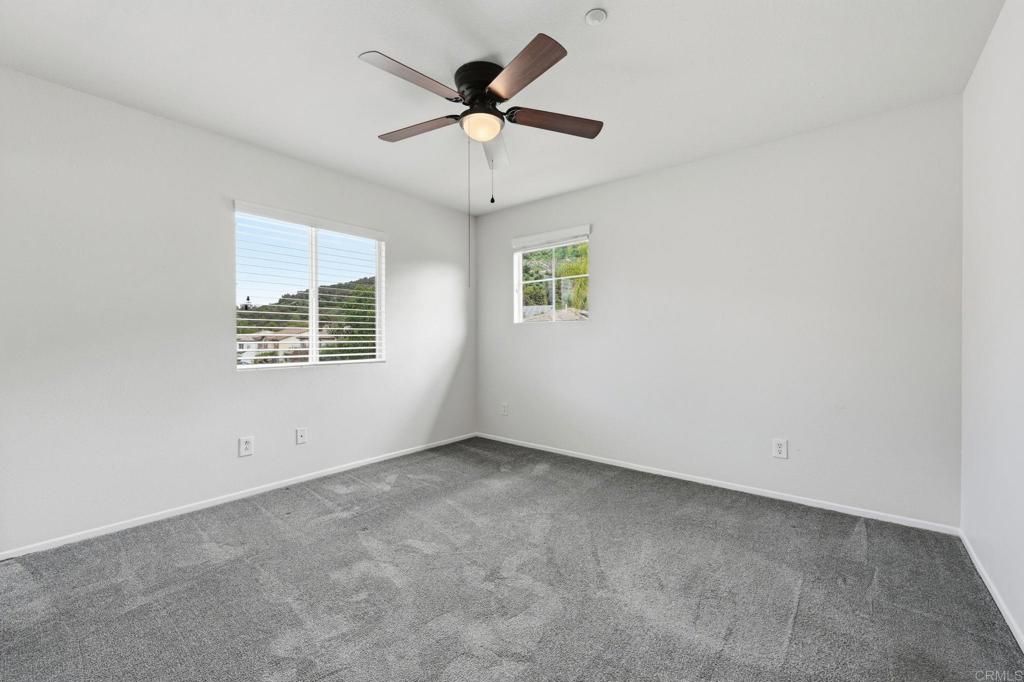 5051 Lake Circle Road Fallbrook, CA 92028 - Photo 40 of 57 an empty room with a window and a fan