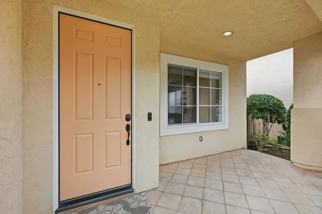 a kitchen with stainless steel appliances a table chairs sink and cabinets