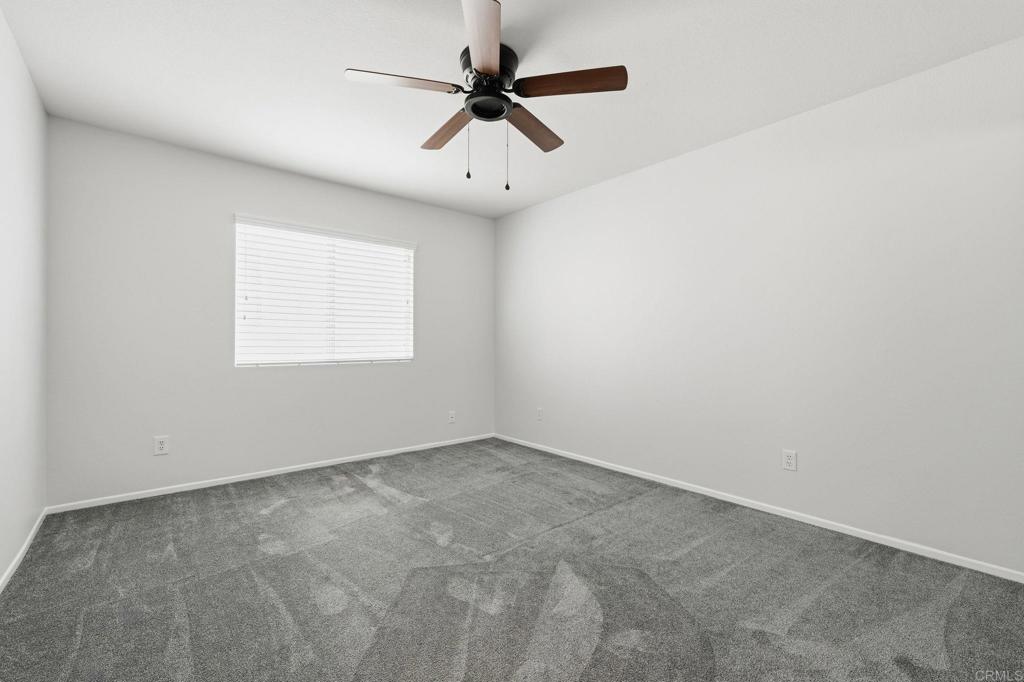5051 Lake Circle Road Fallbrook, CA 92028 - Photo 44 of 57 an empty room with a window and a fan