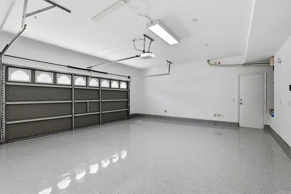 a view of a house with backyard and a tree