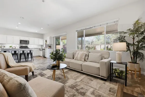 a living room with furniture a fireplace and a large window