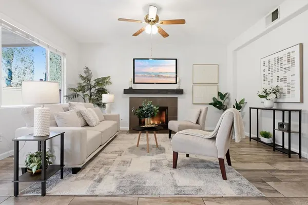 a living room with furniture and kitchen view