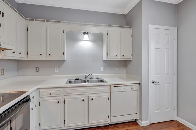a kitchen with white cabinets and a sink