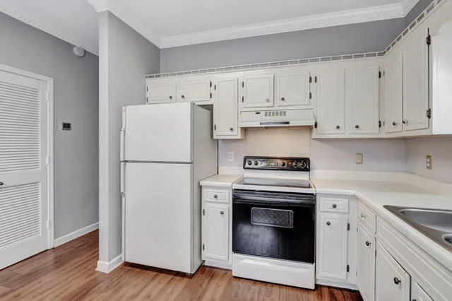 a kitchen with cabinets and steel stainless steel appliances