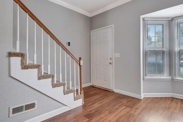 a view of an entryway with wooden floor and door