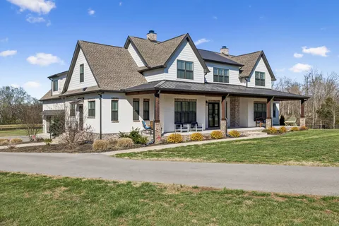 a front view of a house with garden and porch