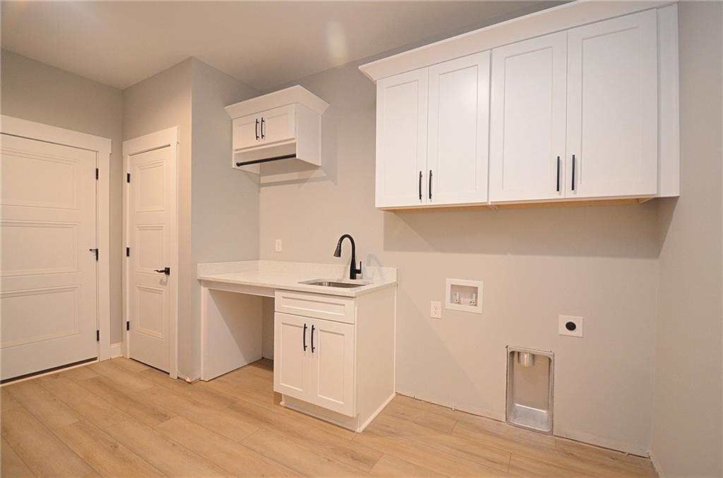1216 Rays River Run Bogart, GA 30622 - Photo 11 of 25 a view of cabinets a sink and dishwasher with wooden floor
