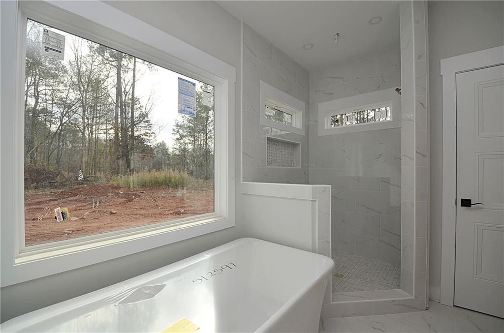 1216 Rays River Run Bogart, GA 30622 - Photo 14 of 25 a bathroom with a bathtub and shower