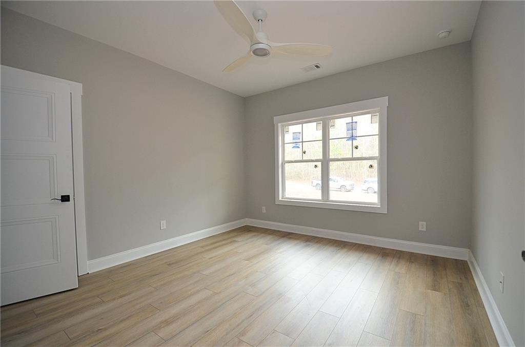 1216 Rays River Run Bogart, GA 30622 - Photo 20 of 25 an empty room with wooden floor and windows