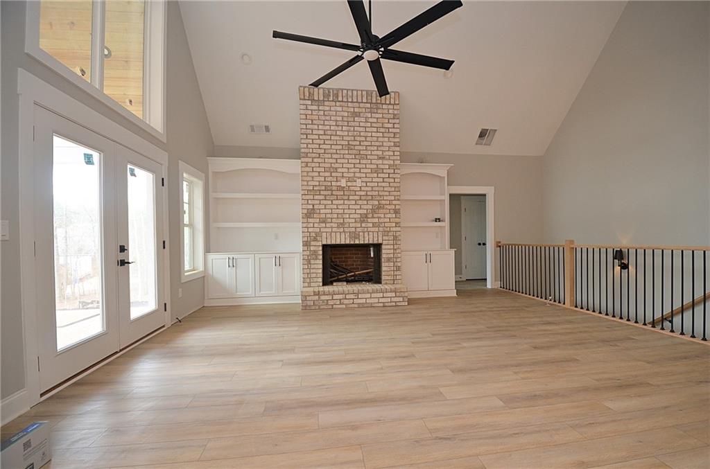 1216 Rays River Run Bogart, GA 30622 - Photo 5 of 25 a view of empty room with wooden floor and fireplace