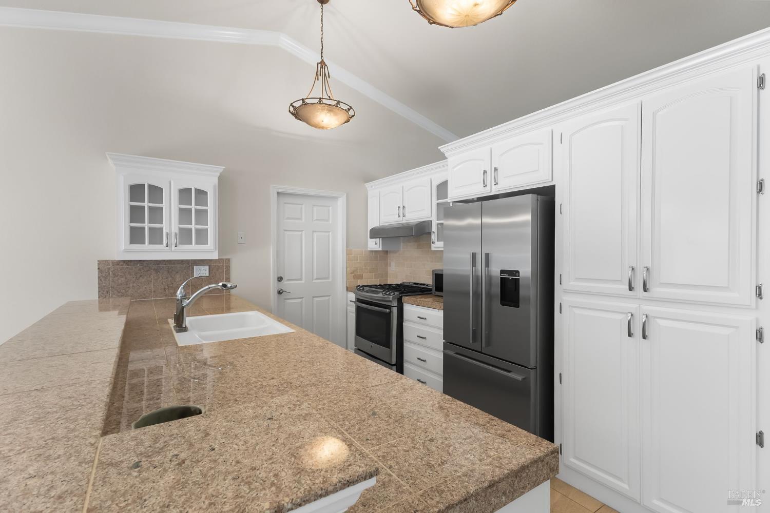 2177 Vista Del Rancho Fairfield, CA 94534 - Photo 11 of 28 a kitchen with kitchen island granite countertop a refrigerator a stove and a sink with wooden floor
