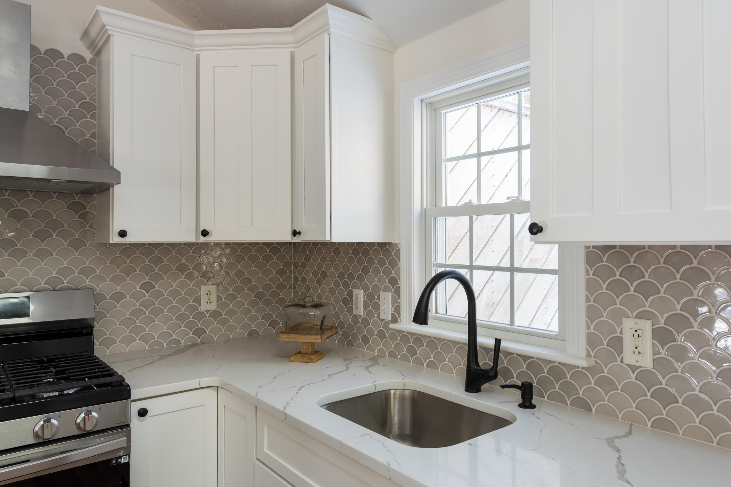 3 Neshobe Road Mashpee, MA 02649 - Photo 17 of 36 a kitchen with granite countertop a sink a window and stainless steel appliances