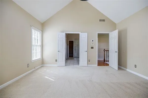 an empty room with windows and closet