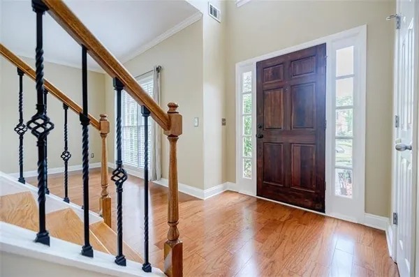 a view of an entryway with wooden floor and staircase