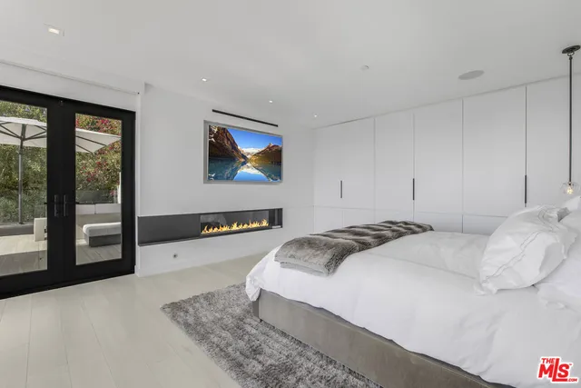 a bedroom with a bed and glass wall