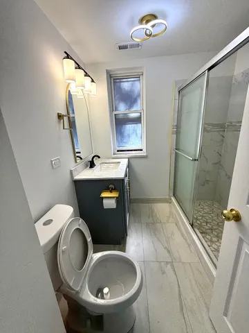 a bathroom with a toilet sink and mirror