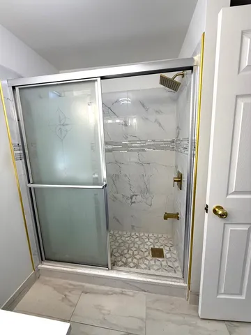 a bathroom with a glass shower door