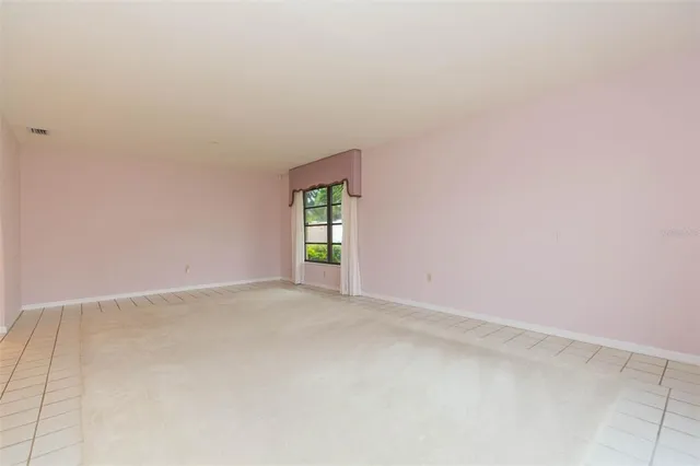 an empty room with closet and fan
