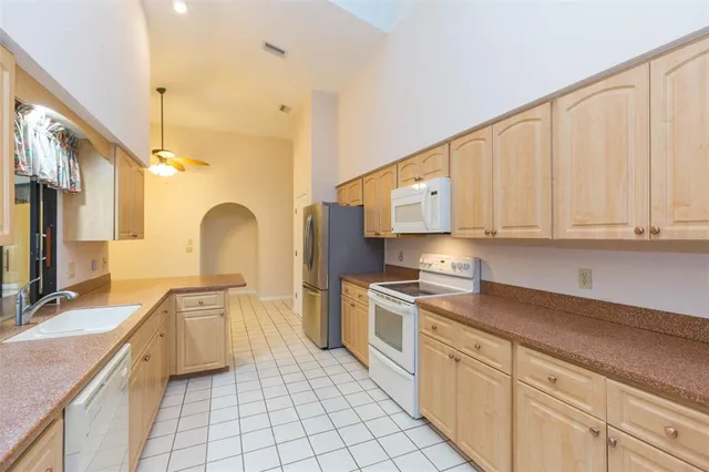 a view of an empty room with window and cabinet