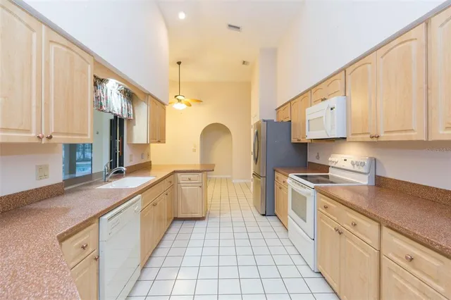 a kitchen with a sink stove and glass door